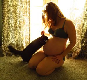 pregnant woman and kitten