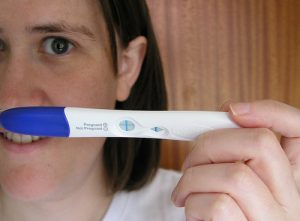 woman with positive pregnancy test